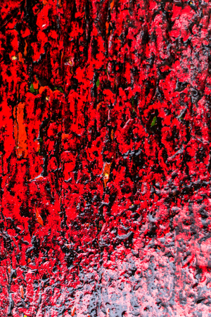 Red paint with dirt and water from a fresh rain storm creates a texture that reminds us of the...
