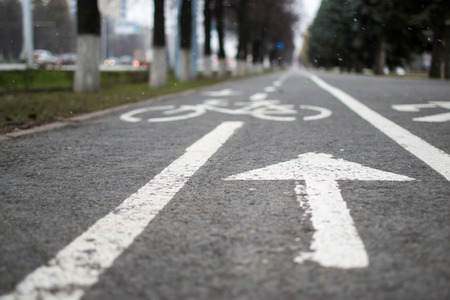 White pedestrian cycle and footpath in white paint with an arrow signの写真素材