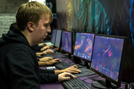 UFA, RUSSIA - NOVEMBER 13, 2015: Young Russian teenagers relax by playing competitive video games as friends in a local Internet bar that specializes in online gaming and LAN parties in Ufa, Russia during November of 2015のeditorial素材