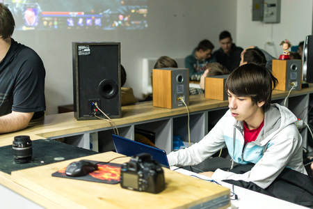 UFA, RUSSIA - NOVEMBER 13, 2015: Young Russian teenagers relax by playing competitive video games as friends in a local Internet bar that specializes in online gaming and LAN parties in Ufa, Russia during November of 2015のeditorial素材