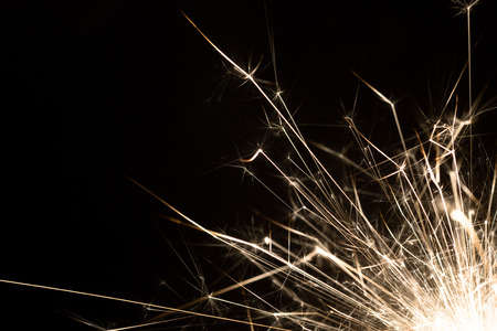 Christmas or New Year celebration close-up of a burning sparkler firework on a black backgroundの写真素材