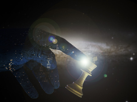 Computer artificial intelligence hand concept of check mate against a white king chess piece. AI technology brain of a robot arm supersedes human power. Copyspace area.の写真素材