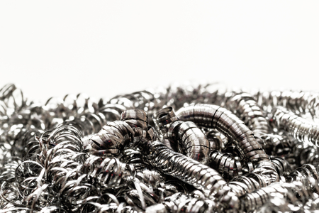 Closeup macro of a metal scrubbing cleaning brush. Repeating patterns of clean unused metallic strands with copy space area for home cleaning designs concepts or ideas.の写真素材