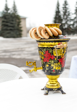 Traditional Russian Samovar in vibrant colours and round bread rollsの写真素材