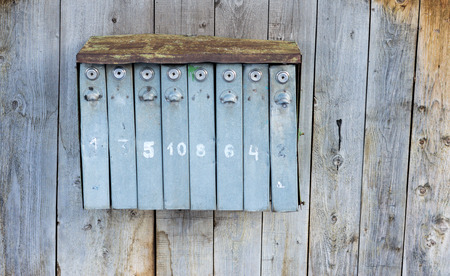 Retro and aged postboxes on a grunge aged wooden background. Grey and light blue colors.の写真素材