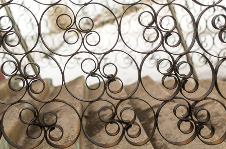Black painted wrought cast iron details show ornate patterns of workmanship.