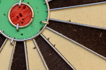Used dart board with holes from darts and copy space area for sport based designs.の写真素材