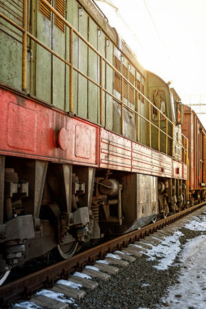 Vintage old diesel powered train moving along a traintrack with bright sunshineの写真素材