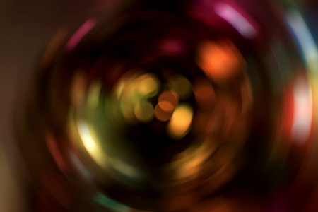 Abstract multicolored lights spinning around creating a whirl of blurred light movement. The spinning colours of create a sense of energy and twisting vibrancy.の写真素材