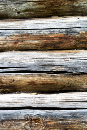 Old dry timber from an old log house. The wooden construction shows signs of age and weatheringの写真素材