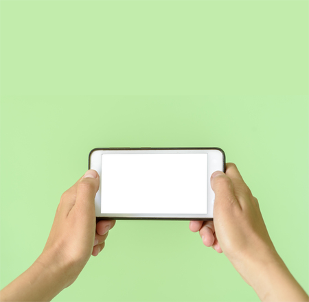 Template of a woman holding a smart device tablet or phone with clipping path for overlaysの写真素材
