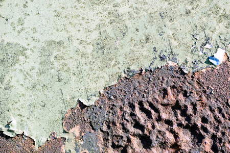 Rust breaks through aged green paint covering the old aged metal beneath the surface copy space area for repair renovation ideas and designsの写真素材