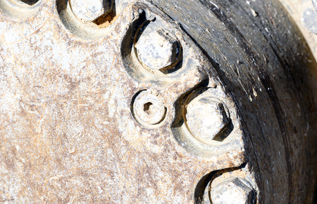 Mud clay encrusted earth moving tracks of a digger excavator machine in color with copy space area for gravel aggregate based ideas and designsの写真素材