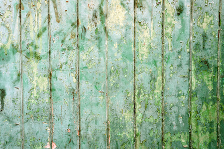 Vintage retro old green paint on flaking aged wood background with organic detail of agingの写真素材