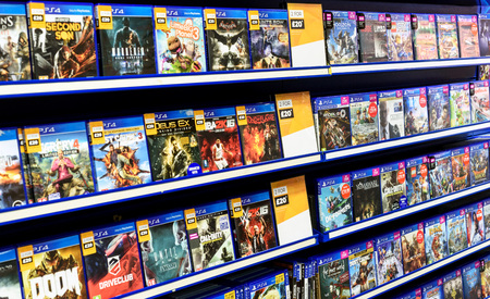 Rows of PS4 video games for consoles on display inside a local Game Store shop in Essex Englandのeditorial素材