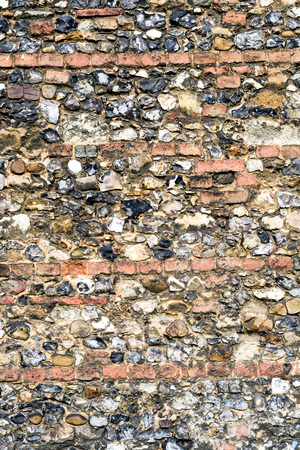 Flint stone wall texture from the aged exterior of a church buildingの写真素材