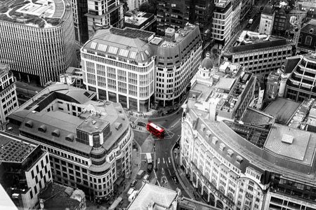 Red Bus ariel view of London City in England with various buildings and busy streets with...