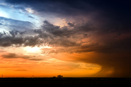 Rainclouds captured at dusk in nautural sunlight with the setting sun creating dark orange hues