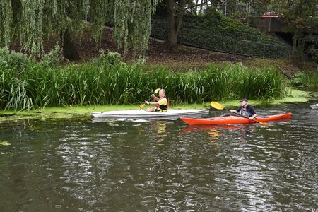 CHELMSFORD, ESSEX/ENGLAND - 18TH AUGUST 2018 - Rowers row their boats on the River Chelmer using the local waterways as part of their watersport activity in the busy city of Chelmsfordのeditorial素材