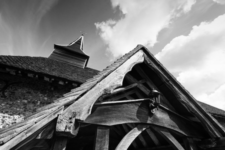 Sinister creepy looking church steeple and roof in an expressionistic style in black and whiteの写真素材
