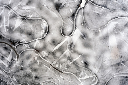 Cracked splt ice in winter caused from frozen water in puddles and wind movement