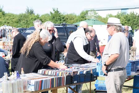CHELMSFORD, ESSEX/ENGLAND - 1ST JUNE 2019 - People visiting a car boot sale in Boreham Essex browsing CDs and where they can also buy cheap and unusual items during the summer of 2019のeditorial素材