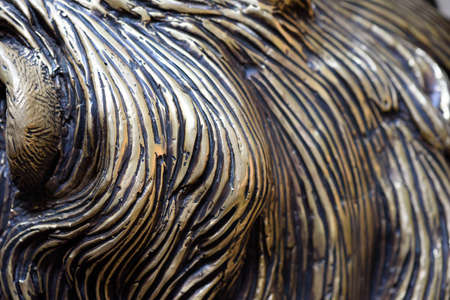 Bronze carving details in closeup macro view with attention to the strikes and curves of bronze and molten lead forming a unique pattern in metalの写真素材