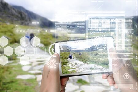 Augmented Reality device using smart technology, mixing virtual and augmentation reality through the application of artificial intelligence and computer AI tech assistance for tourist adventure holidaysの写真素材