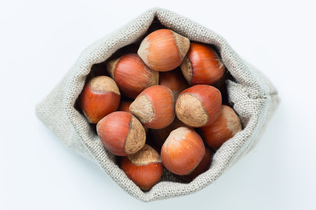 Hazelnuts in the linen bag isolatedの写真素材