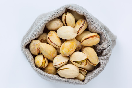 Isolated pistachios in the linen bagの写真素材