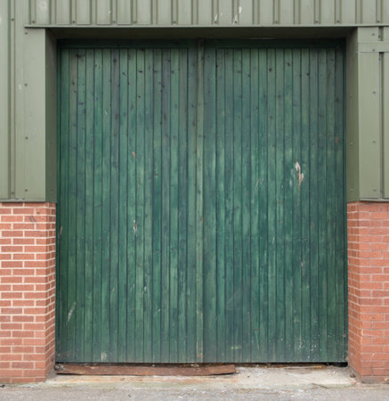 Green woodstain used on a cheaply constructed door の写真素材