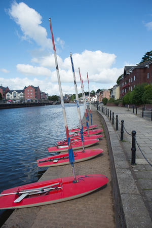 A row of sailboats waits for the next class to appear.の写真素材