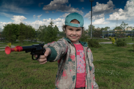 a little girl with a toy gunの写真素材