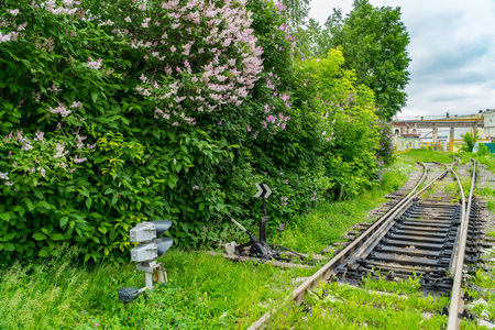 Railway track leading to the loading and unloading industrial buildingの写真素材