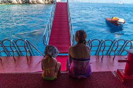 Mother and young daughter are traveling in the Mediterranean sea on the shipの写真素材