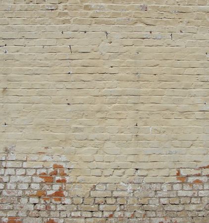 yellow worn painted brick wall                               の写真素材