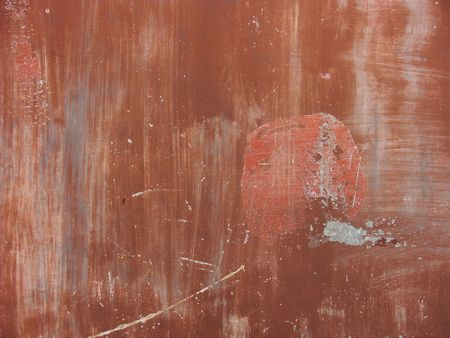 worn painted red metal surface  with scratches and dirt                             の写真素材