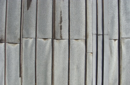 side wall of a house with wood and zinc or lead attached                               