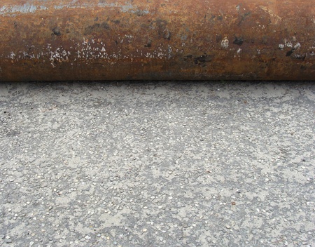 industrial rusty steel pipe laying on pavementの写真素材