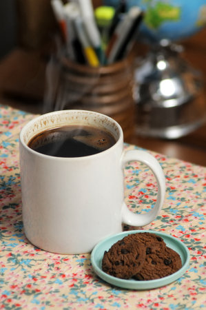 Morning coffee with a mug of black coffee and choco chipsの写真素材