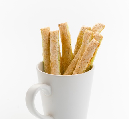 Bread sticks in a empty mug of coffee great for your snacksの写真素材