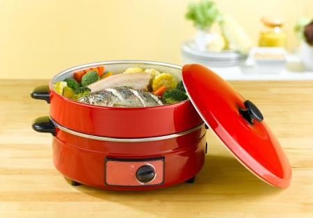 Double steaming electric pot for steam cooking and frying foodの写真素材