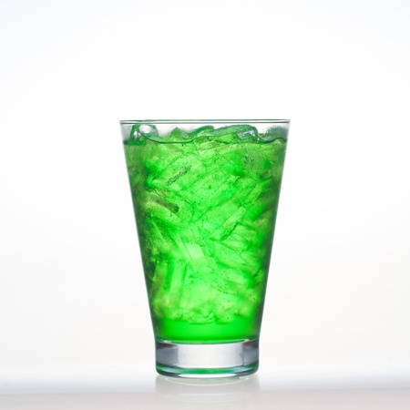 Green fruit flavor soft drinks whit soda water isolated on whiteの写真素材