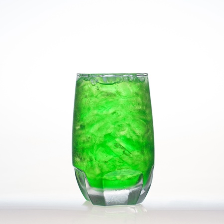 Green fruit flavor soft drinks whit soda water isolated on whiteの写真素材