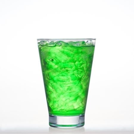 Green fruit flavor soft drinks whit soda water isolated on whiteの写真素材