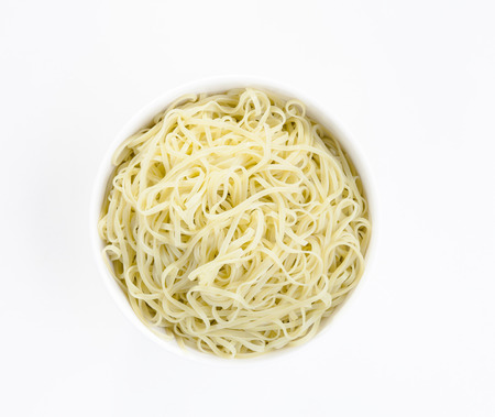 Organic noodle in a bowl isolated on white background の写真素材