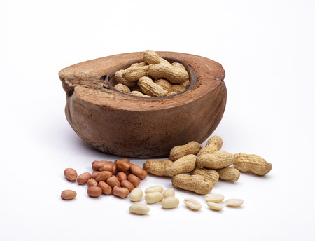 Peanuts in the coconut bowl isolated on white background