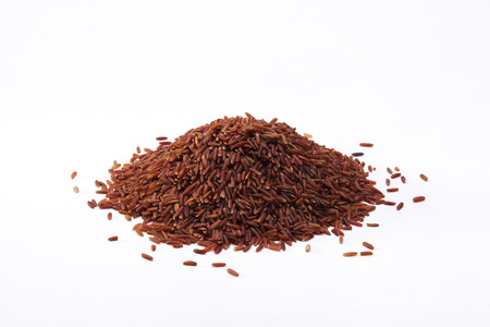Heap of Thai organic brown rice isolated on white backgroundの写真素材