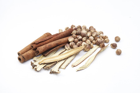 Cardamom cinnamon and liquorice herbs for cooking isolated on white の写真素材