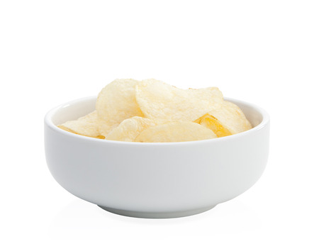Slice potato chips arranges in a bowl isolated on white backgroundの写真素材